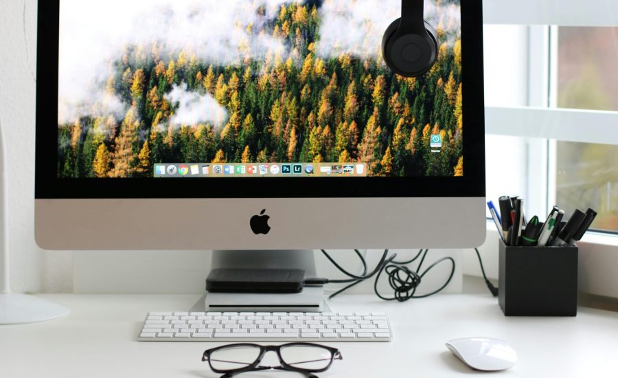 Free Stylish home office workspace featuring a computer setup with accessories. Stock Photo