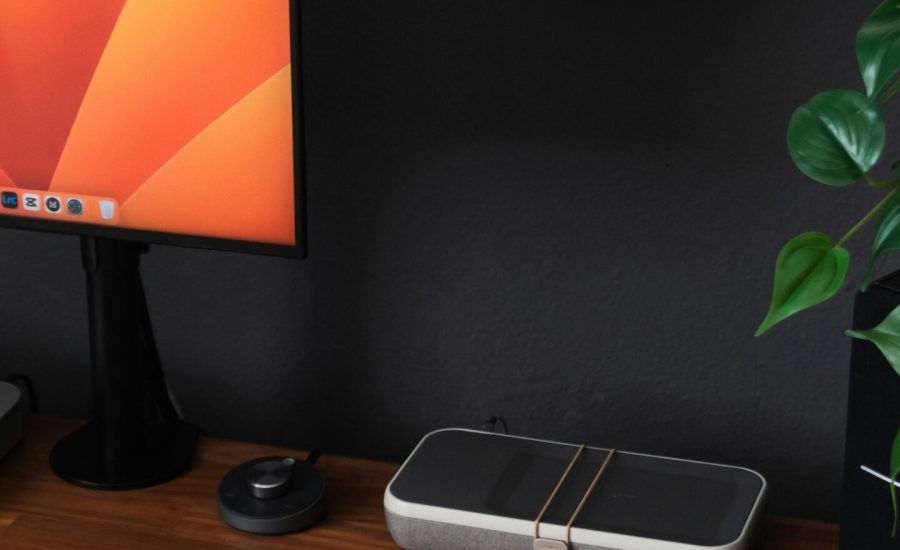 a desk with a laptop, keyboard, mouse and a monitor